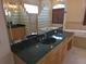Luxurious bathroom featuring a vanity with dual sinks, a soaking tub, and a glass block shower at 9188 Mississippi Run, Weeki Wachee, FL 34613