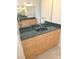 Bathroom vanity features dual sinks, granite countertop, and wood cabinetry at 9188 Mississippi Run, Weeki Wachee, FL 34613