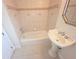 Well-lit bathroom features a pedestal sink, tile flooring, and decorative trim at 9188 Mississippi Run, Weeki Wachee, FL 34613