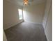 Well-lit bedroom with plush carpet, neutral paint, and a ceiling fan at 9188 Mississippi Run, Weeki Wachee, FL 34613