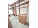 Large walk-in closet features custom wood shelving and built-in drawers at 9188 Mississippi Run, Weeki Wachee, FL 34613