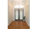 Inviting foyer featuring decorative double doors, a chandelier, and hardwood flooring at 9188 Mississippi Run, Weeki Wachee, FL 34613
