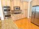 Well-appointed kitchen featuring stainless steel appliances, granite countertops, and custom cabinets at 9188 Mississippi Run, Weeki Wachee, FL 34613