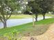 Scenic view of a tranquil lake framed by mature trees and lush landscaping at 9188 Mississippi Run, Weeki Wachee, FL 34613