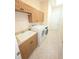 Functional laundry room with ample cabinet space, utility sink, and modern appliances at 9188 Mississippi Run, Weeki Wachee, FL 34613