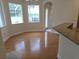 Cozy breakfast nook with hardwood flooring, large windows providing natural light, and access to the porch at 9188 Mississippi Run, Weeki Wachee, FL 34613