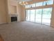 Bright living room features a fireplace, chandelier, and sliding glass doors leading to the pool area at 9188 Mississippi Run, Weeki Wachee, FL 34613
