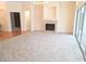 Spacious living room with neutral carpet, fireplace, and sliding glass doors to the outside at 9188 Mississippi Run, Weeki Wachee, FL 34613