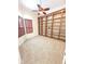 Home office boasts custom built-in bookshelves, plush carpet, and plantation shutters at 9188 Mississippi Run, Weeki Wachee, FL 34613