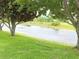 Scenic view of a pond surrounded by lush greenery and trees, offering a tranquil outdoor space at 9188 Mississippi Run, Weeki Wachee, FL 34613