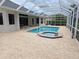 A pristine pool and spa are surrounded by a screened enclosure and paver deck at 9188 Mississippi Run, Weeki Wachee, FL 34613