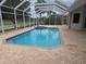 A pristine pool and spa are surrounded by a screened enclosure and paver deck at 9188 Mississippi Run, Weeki Wachee, FL 34613
