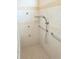 Accessible shower with grab bars, multiple shower heads, and tiled walls at 9188 Mississippi Run, Weeki Wachee, FL 34613
