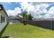 Spacious backyard with lush green grass and a screened-in pool area at 9212 Calle Alta, New Port Richey, FL 34655