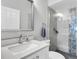 Updated bathroom with a single sink vanity, glass-enclosed shower, and modern fixtures at 9212 Calle Alta, New Port Richey, FL 34655