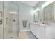 Bathroom featuring a glass enclosed shower with updated white double sink vanity at 9212 Calle Alta, New Port Richey, FL 34655