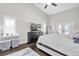 Light-filled primary bedroom with dark hardwood floors, vaulted ceiling and adjacent closet at 9212 Calle Alta, New Port Richey, FL 34655