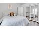 Bright bedroom featuring a comfortable bed, mirrored closet, and cute decor at 9212 Calle Alta, New Port Richey, FL 34655