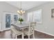 Cozy dining area featuring a stylish light fixture and a view of the outdoors at 9212 Calle Alta, New Port Richey, FL 34655