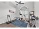 Bright exercise room features vaulted ceilings, large arched window and modern fitness equipment at 9212 Calle Alta, New Port Richey, FL 34655