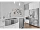 Modern kitchen with stainless steel appliances, a large sink, and ample counter space at 9212 Calle Alta, New Port Richey, FL 34655