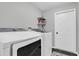 Well-lit laundry room with modern washer and dryer, complemented by neutral walls and tile flooring at 9212 Calle Alta, New Port Richey, FL 34655