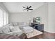 Spacious living room with a comfortable gray sectional, ceiling fan and tile flooring at 9212 Calle Alta, New Port Richey, FL 34655