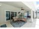 Screened-in patio features a comfortable lounge area and access to the pool at 9212 Calle Alta, New Port Richey, FL 34655
