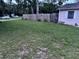 Large grass backyard surrounded by a wooden fence for privacy and greenery at 9536 Mayson St, New Port Richey, FL 34654