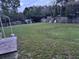 Expansive backyard featuring a wooden fence, shed, and lush green grass, perfect for outdoor activities at 9536 Mayson St, New Port Richey, FL 34654