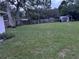 Large backyard with a wooden fence and a storage shed at 9536 Mayson St, New Port Richey, FL 34654