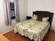 Cozy bedroom featuring a queen bed, hardwood floors, with a window view at 9536 Mayson St, New Port Richey, FL 34654