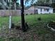 Well-maintained yard with a charming house, a sturdy wooden fence and beautiful plants, providing a serene outdoor space at 9536 Mayson St, New Port Richey, FL 34654