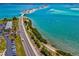 Aerial view of a bridge connecting a beach and mainland over turquoise water at 2827 Oak Tree Ln, Palm Harbor, FL 34684