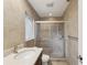 This bathroom features a glass enclosed shower with tile accents and a vanity with stone countertop at 2827 Oak Tree Ln, Palm Harbor, FL 34684
