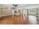 Open living room featuring hardwood floors with an open floor plan and views to the kitchen at 2827 Oak Tree Ln, Palm Harbor, FL 34684