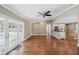 Open living room featuring hardwood floors with french doors opening up to the backyard pool area at 2827 Oak Tree Ln, Palm Harbor, FL 34684