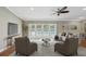 Bright living room featuring neutral furnishings, and sliding glass doors providing pool views at 2827 Oak Tree Ln, Palm Harbor, FL 34684