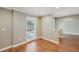 Cozy living room with hardwood floors, a white trim window and neutral-colored walls at 2827 Oak Tree Ln, Palm Harbor, FL 34684