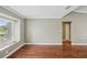 Open living room featuring hardwood floors, crown molding, and a bright window at 2827 Oak Tree Ln, Palm Harbor, FL 34684