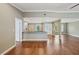 Open-concept living area with wood floors leading to a kitchen and front entry at 2827 Oak Tree Ln, Palm Harbor, FL 34684