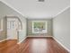 Neutral living room showcasing hardwood floors, an archway, and a bright window at 2827 Oak Tree Ln, Palm Harbor, FL 34684