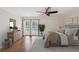 Comfortable main bedroom features French doors to the pool and neutral decor at 2827 Oak Tree Ln, Palm Harbor, FL 34684