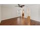 Main bedroom with hardwood floors, ceiling fan, ensuite bathroom and a closet at 2827 Oak Tree Ln, Palm Harbor, FL 34684