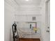 This utility room features white wire shelving, and access to utilities at 2827 Oak Tree Ln, Palm Harbor, FL 34684