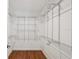 Walk-in closet features adjustable metal shelving with room for storage at 2827 Oak Tree Ln, Palm Harbor, FL 34684