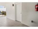 Private hallway with tiled floors and a fire extinguisher at 1558 4Th St # 406, Sarasota, FL 34236
