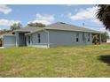 Beautiful backyard showing a well-manicured lawn and new construction at 310 Day Break Cir, Port Charlotte, FL 33954
