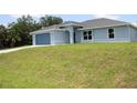 Exterior of home showing manicured lawn and blue paint at 310 Day Break Cir, Port Charlotte, FL 33954
