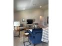 Bright living room featuring comfortable seating and a large TV at 1139 Euclid Rd, Venice, FL 34293